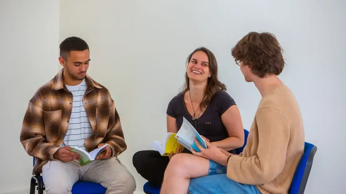 People joyfully studying Buddhist teachings and the works of Ven Geshe Kelsang Gyatso