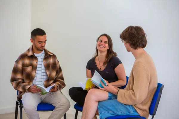 People joyfully studying Buddhist teachings and the works of Ven Geshe Kelsang Gyatso