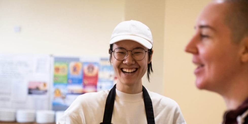 Siling happy person helping out volunteering at Buddhist centre