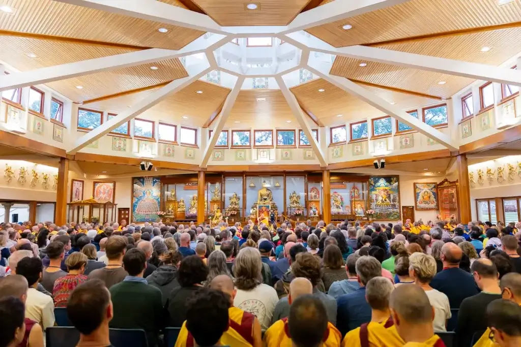 Lots of people enjoying buddhist teachings and meditating in the beautiful kadampa buddhist temple.
