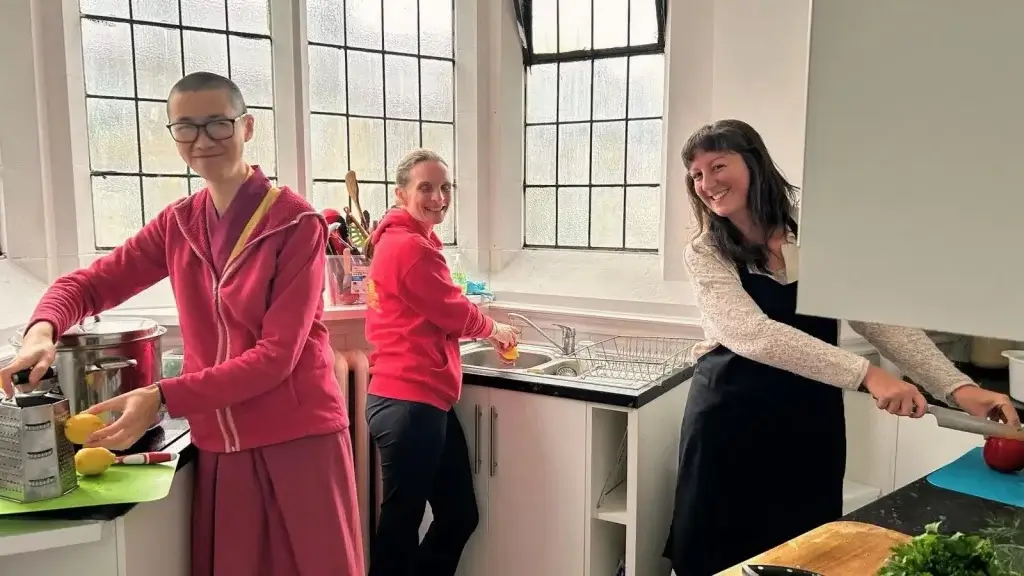 People helping out doing dishes at the Buddhist centre